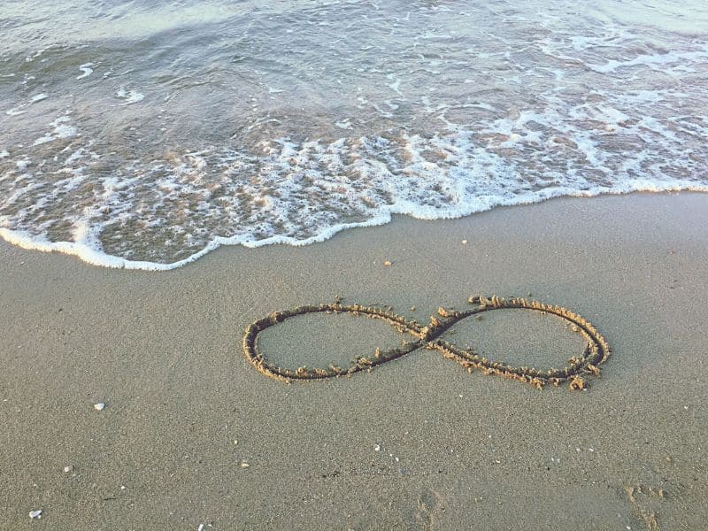 infinity symbol drawn on sand